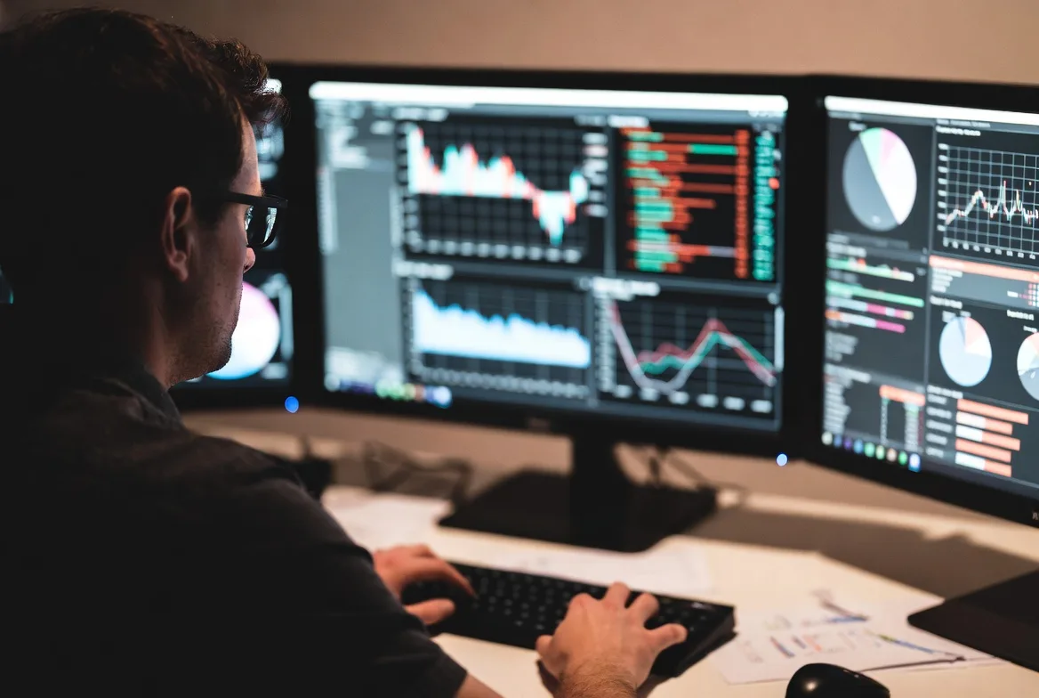 analyst reviewing crypto data sources on multiple screens