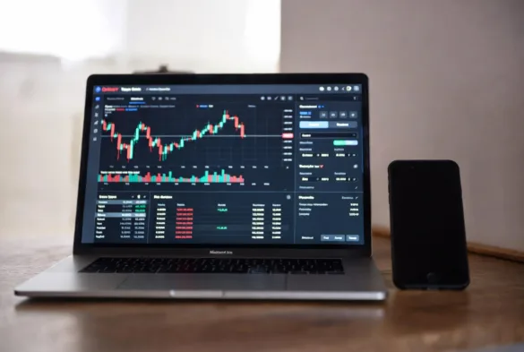 automated crypto trading bot running on laptop with charts